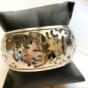 Sliver bangle with an expensive bracelet pattern.